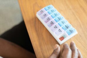 Weekly pill organizer on a table used for medication management